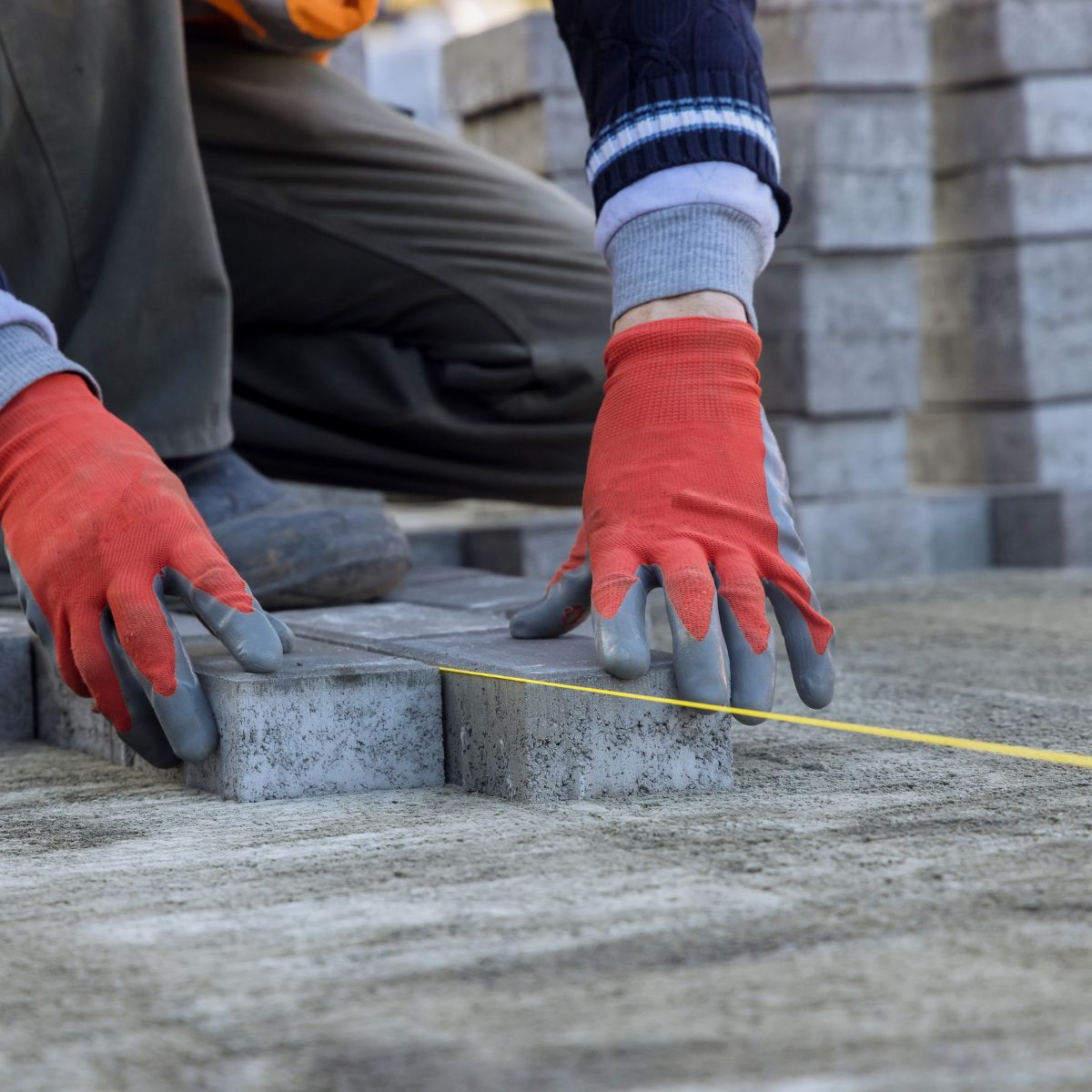 Pavers being installed with a straight line for precision